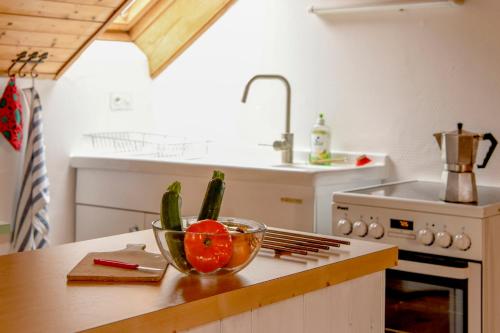 a kitchen with a bowl of vegetables on a counter at Wild Valley Village Life Apartment in Onsernone in Loco