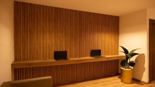 a lobby with two laptops on a wooden wall at Jasmin Ain Zaghouane in El Aouina Station