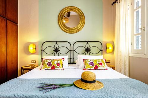 a bedroom with a bed with a hat on it at Chanialiving Venetian Luxury House-near Plaza Parking in Chania Town