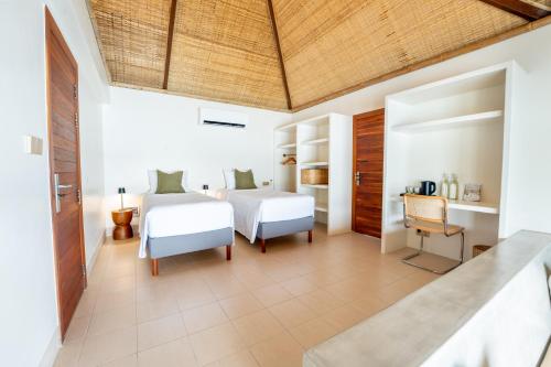 a bedroom with two beds and a desk at Wake Park Cambodia in Siem Reap