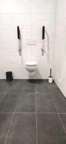 a bathroom with a toilet and two phones on the wall at Hotel FFA 62 in Berlin