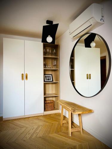 a room with a wooden table and a mirror at Steyr Old Town Loft - A charming 3 Bedroom Oasis in Steyr