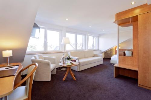ein Wohnzimmer mit einem Sofa und einem Tisch in der Unterkunft Gasthof Tepferdt in Rees