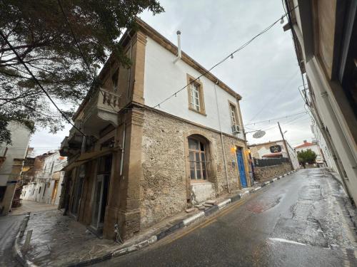 an old building on the side of a street at Deniz Konak Boutique Hotel in Kérynia