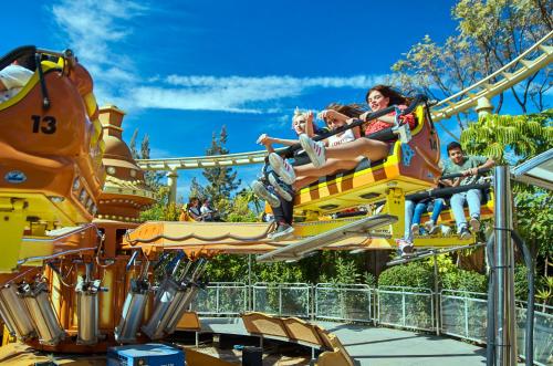 a group of people riding on a roller coaster at Hotel Magic Fantasy in Oropesa del Mar