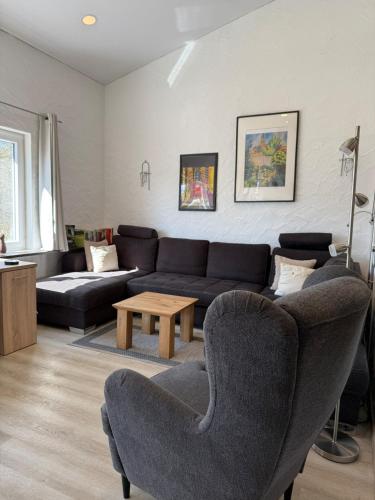 a living room with a couch and chairs and a table at Ferienhaus Stausee Bitburg in Biersdorf am See