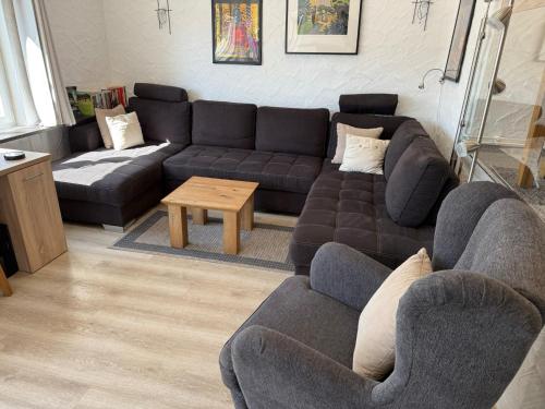 a living room with a couch and a table at Ferienhaus Stausee Bitburg in Biersdorf am See
