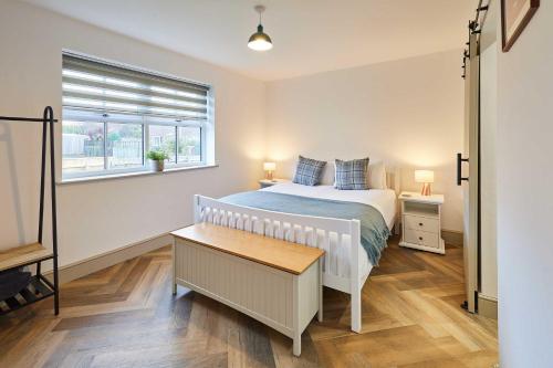 a bedroom with a large bed and a window at Host & Stay - Middle Cottage in Seahouses