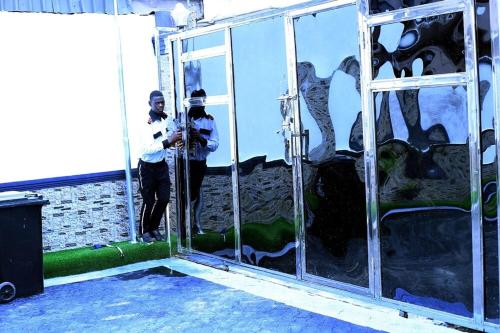 a man taking a picture of himself in a mirror at Luxurious Lukes Apartment in Benin City