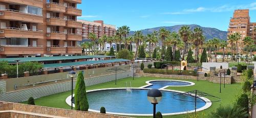 a resort with a swimming pool in a park at Marina d'Or Edificio Fase X - 1ª linea apartment in El Borseral