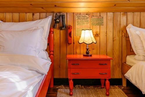 a bedroom with a bed and a lamp on a night stand at Casa cu Amintiri - Authentic Cozy Cottage in Bran