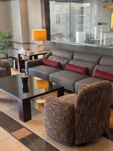 a living room with a couch and a table at Ny Suites in Beirut