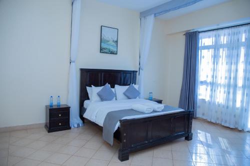 a bedroom with a large bed and a window at Barsalinga Towers in Isiolo