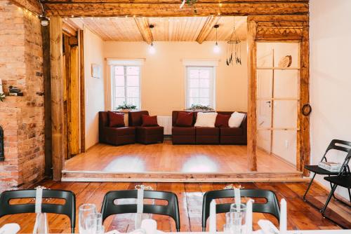 a living room with a couch and a table at Holiday House LIL Home in Krāslava