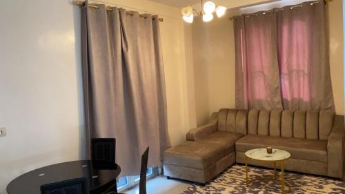 a living room with a couch and a table at Milky House in Nkomo