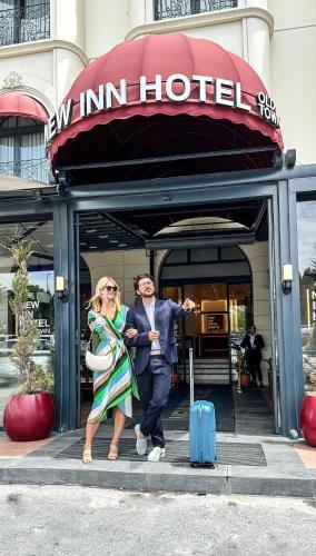 a man and a woman walking out of a hotel at New Inn Hotel Old Town in Istanbul