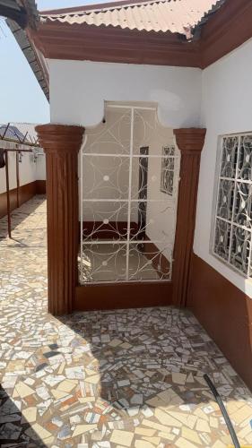 a front door of a house with a glass at Marongs Appartment in Djalabango