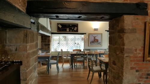 a dining room with a table and chairs at The Priest House On The River in Castle Donington