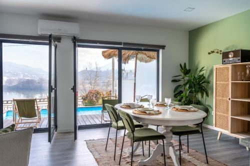 a dining room with a table and chairs with a view at Feel Discovery Casa DAlice in Peso da Régua