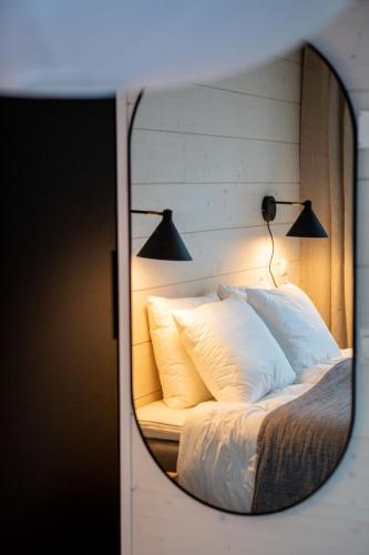 a reflection of a bed with pillows in a mirror at Villa Alaska in Syöte