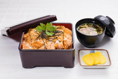 a lunch box with food and a bowl of soup at HOTEL PAL Otsuka -Adult Only- in Tokyo