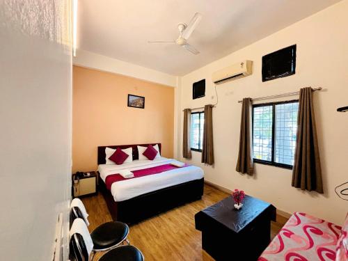 a hotel room with a bed and a couch at Hotel Sunrise Inn in Kota