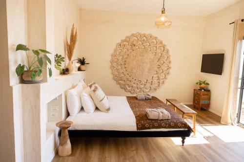 a bedroom with a bed and a large mirror at Beit Oren Hotel in Bet Oren