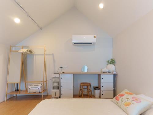 a bedroom with a desk and a bed and a desk at hiddenmoon cottage in Bangkok