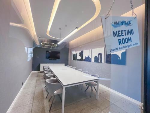 a meeting room with a white table and chairs at Ls apartment in Midrand