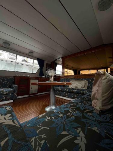 a room on a boat with a table and chairs at Sea Panther in Il-Gżira