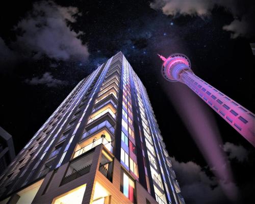 a tall building with a needle on the side of it at Apartment in Auckland City in Front of Sky Tower in Auckland