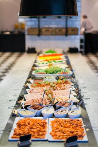 a buffet line with many different types of food at Best Western Plus Hotel Plaza in Västerås