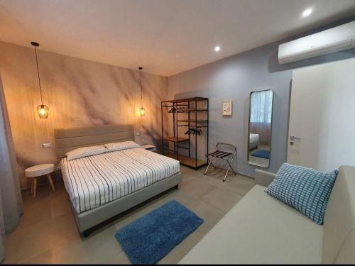 a bedroom with a bed and a table and a mirror at Playa-degli-Angeli-SCIROCCO in Gabicce Mare