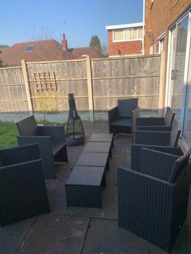 a group of chairs and tables on a patio at Spacious 5 Bedroom House - Sleeps 7 - 3-Car Driveway - Work - Leisure in Wolverhampton