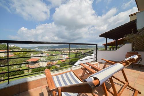 a balcony with two chairs and a view at Sea View Maria in Fourka