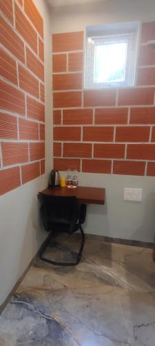 a corner of a room with a brick wall at The Hills Studio Appartment in Tiruvannāmalai