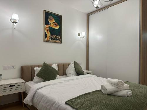 a bedroom with a bed with towels on it at Panoramic RESIDENCE in Baia Mare