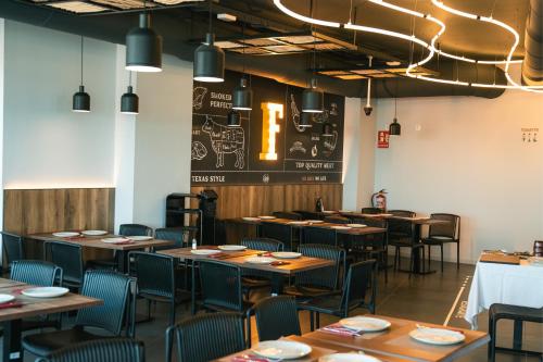 a dining room with wooden tables and chairs at Hotel Magic Sports 4 in Oropesa del Mar