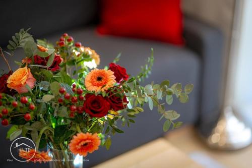 a bouquet of flowers in a vase on a table at Les vieilles tours Bellevue Parking in Chambéry