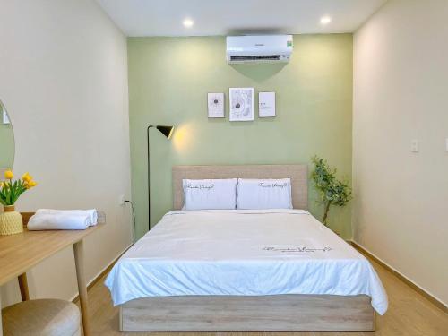 a bedroom with a large bed with a white bedspread at Erica's House - Oceanview The Sóng Apartment Vũng Tàu Nghỉ Dưỡng Biển Cao Cấp 5 Sao - The Song Vung Tau Condotel 5 Star Beach View Apartment in Vung Tau