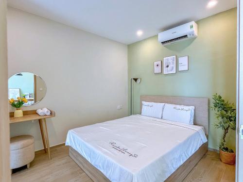 a bedroom with a bed and a air conditioner on the wall at Erica's House - Oceanview The Sóng Apartment Vũng Tàu Nghỉ Dưỡng Biển Cao Cấp 5 Sao - The Song Vung Tau Condotel 5 Star Beach View Apartment in Vung Tau