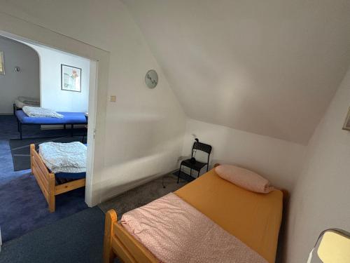 a small room with two beds and a room with a bed at Apartment Hope Inn in Groß-Zimmern