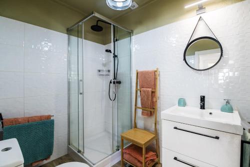 a bathroom with a shower and a sink and a mirror at Carvoeiro Beach Apartment in Carvoeiro