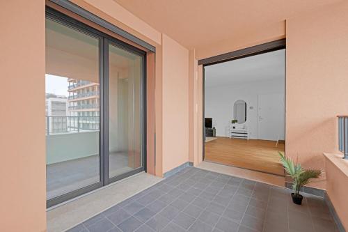a balcony with sliding glass doors with a view of a room at Cefalonia Garden with Terrace & Garage by NDP rent in Milan