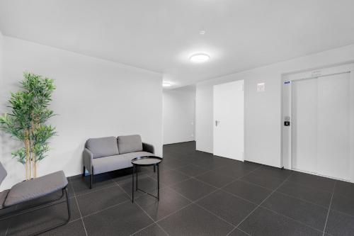 a waiting room with a chair and a table at Cefalonia Garden with Terrace & Garage by NDP rent in Milan