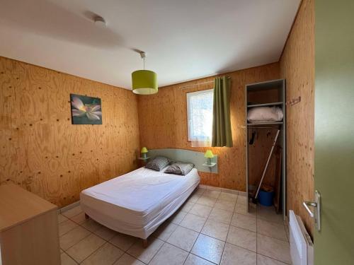 une petite chambre avec un lit et une fenêtre dans l'établissement Escapade au bord du lac, Double maison, à Giffaumont