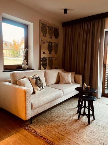a living room with a couch and a table at Sleep & Sheep in Kościelisko