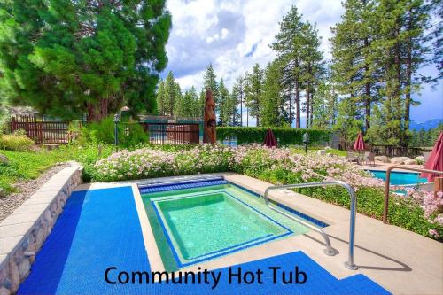 a swimming pool with a hot tub in a yard at Chimney Rock Condo condo in Stateline