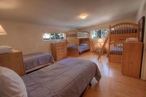 a bedroom with two beds and two bunk beds at Foothill Folly home in Zephyr Cove