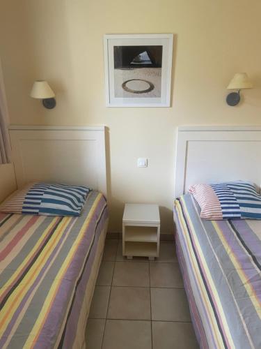 En eller flere senge i et værelse på Appartement T2 plein sud aux Sables d'Olonne